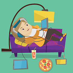 Image showing Woman lying on sofa with many gadgets.