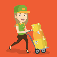 Image showing Delivery postman with cardboard boxes on trolley.