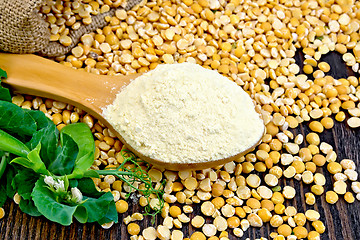 Image showing Flour pea in spoon on dark board