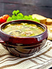 Image showing Soup with meatballs and mushrooms in pottery on dark board