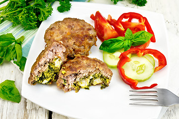 Image showing Cutlets stuffed with basil in plate on board