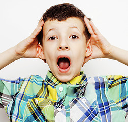 Image showing young pretty little cute boy kid wondering, posing emotional face isolated on white background, gesture happy smiling closeup, lifestyle people concept