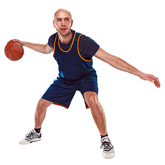 Image showing Full length portrait of a basketball player with ball