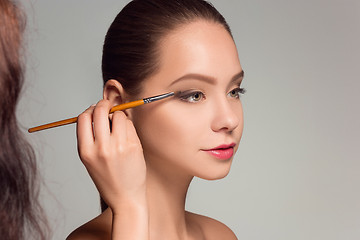 Image showing Beautiful female eyes with make-up and brush