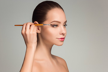 Image showing Beautiful female eyes with make-up and brush