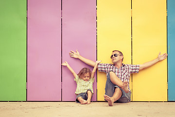 Image showing Father and son playing near the house at the day time.