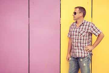 Image showing  man looking away standing near the wall.