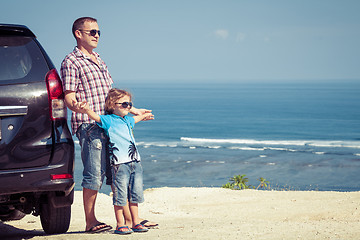 Image showing Father and son playing on the beach at the day time.