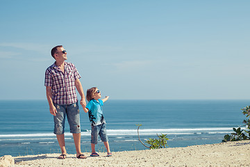 Image showing Father and son playing on the beach at the day time.