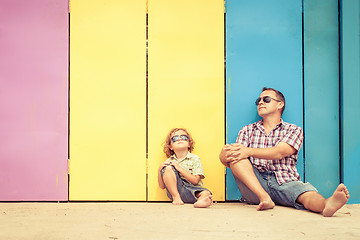 Image showing Father and son playing near the house at the day time.