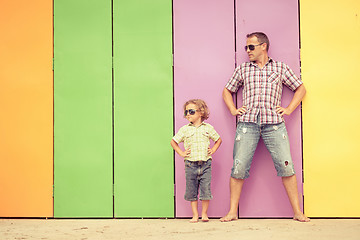 Image showing Father and son playing near the house at the day time.