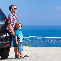 Image showing Father and son playing on the beach at the day time. 