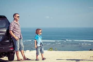 Image showing Father and son playing on the beach at the day time.