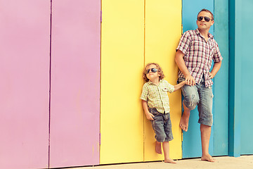 Image showing Father and son playing near the house at the day time.