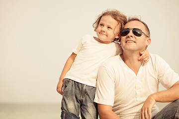 Image showing Father and son playing on the beach at the day time.