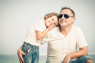 Image showing Father and son playing on the beach at the day time.