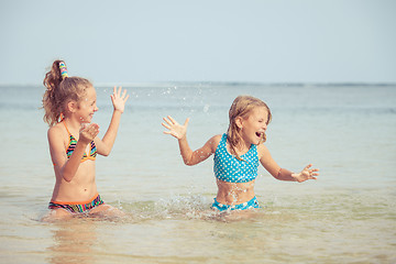 Image showing Two happy children  playing on the beach