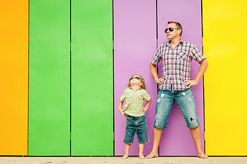 Image showing Father and son playing near the house at the day time.