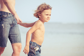 Image showing Mother and son playing on the beach at the day time.