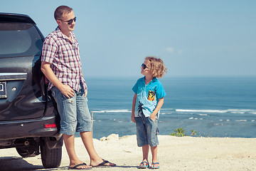 Image showing Father and son playing on the beach at the day time.