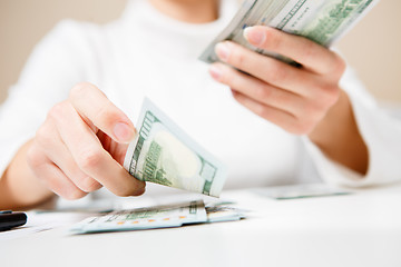 Image showing Hands counting money, close up