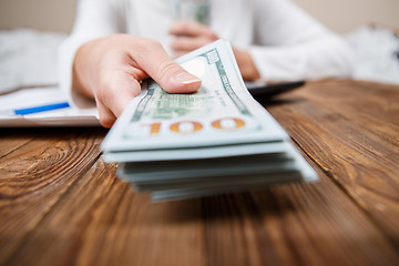 Image showing Hands of person proposing money to you - closeup shot