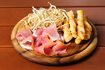 Image showing Beer snacks on wooden plate