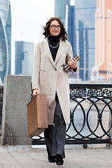 Image showing Smiling businesswoman in a light coat