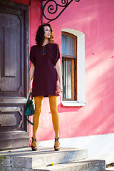 Image showing beautiful woman on the porch of an old building