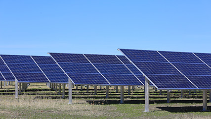 Image showing Solar Panels on a Field with Blue Sky