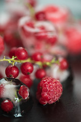 Image showing Frozen berries on wooden table