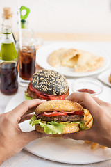 Image showing Man eating burgers