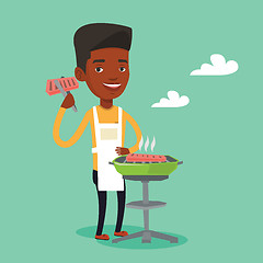 Image showing Man cooking steak on barbecue grill.