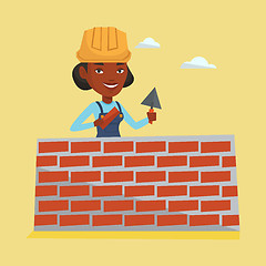 Image showing Bricklayer working with spatula and brick.