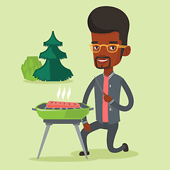 Image showing Man cooking steak on barbecue grill.