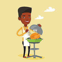 Image showing Man cooking chicken on barbecue grill.