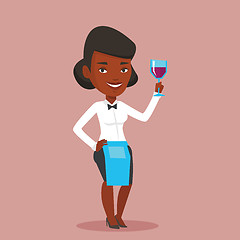 Image showing Bartender holding a glass of wine in hand.