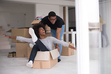 Image showing African American couple  playing with packing material