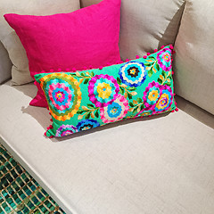 Image showing Bright cushions with floral design on a sofa