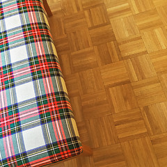 Image showing Checked textile banquette on parquet floor