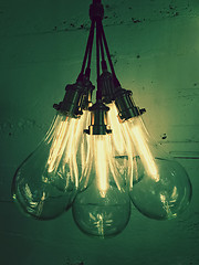 Image showing Bunch of light bulbs giving green light