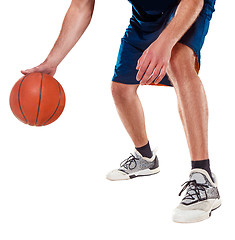 Image showing The legs of a basketball player with ball