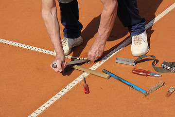 Image showing Worker Repairing lines on a tennis court