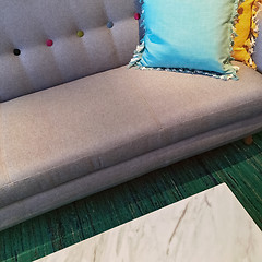 Image showing Gray sofa with blue and yellow cushions