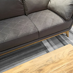 Image showing Comfortable gray sofa and wooden coffee table