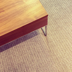 Image showing Simple wooden table on carpet floor