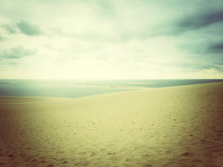 Image showing Hazy landscape with sea and sand dunes