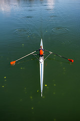 Image showing Young woman rowing in boat on the lake