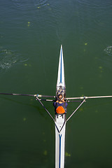 Image showing Young woman rowing in boat on the lake