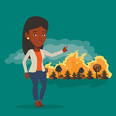 Image showing Woman standing on background of wildfire.
